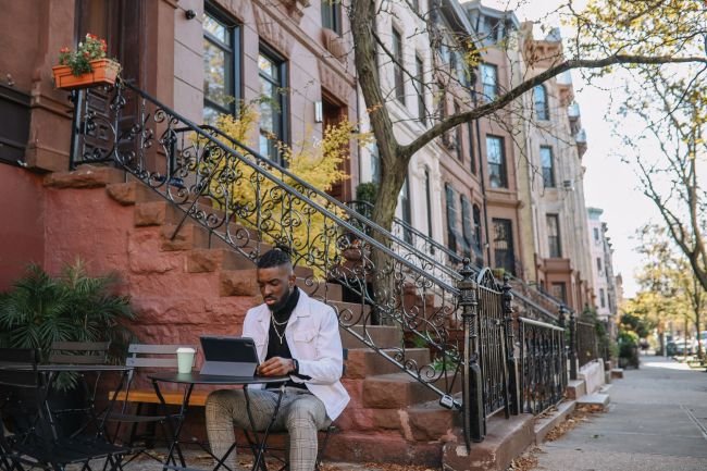 man working outside coffee shop